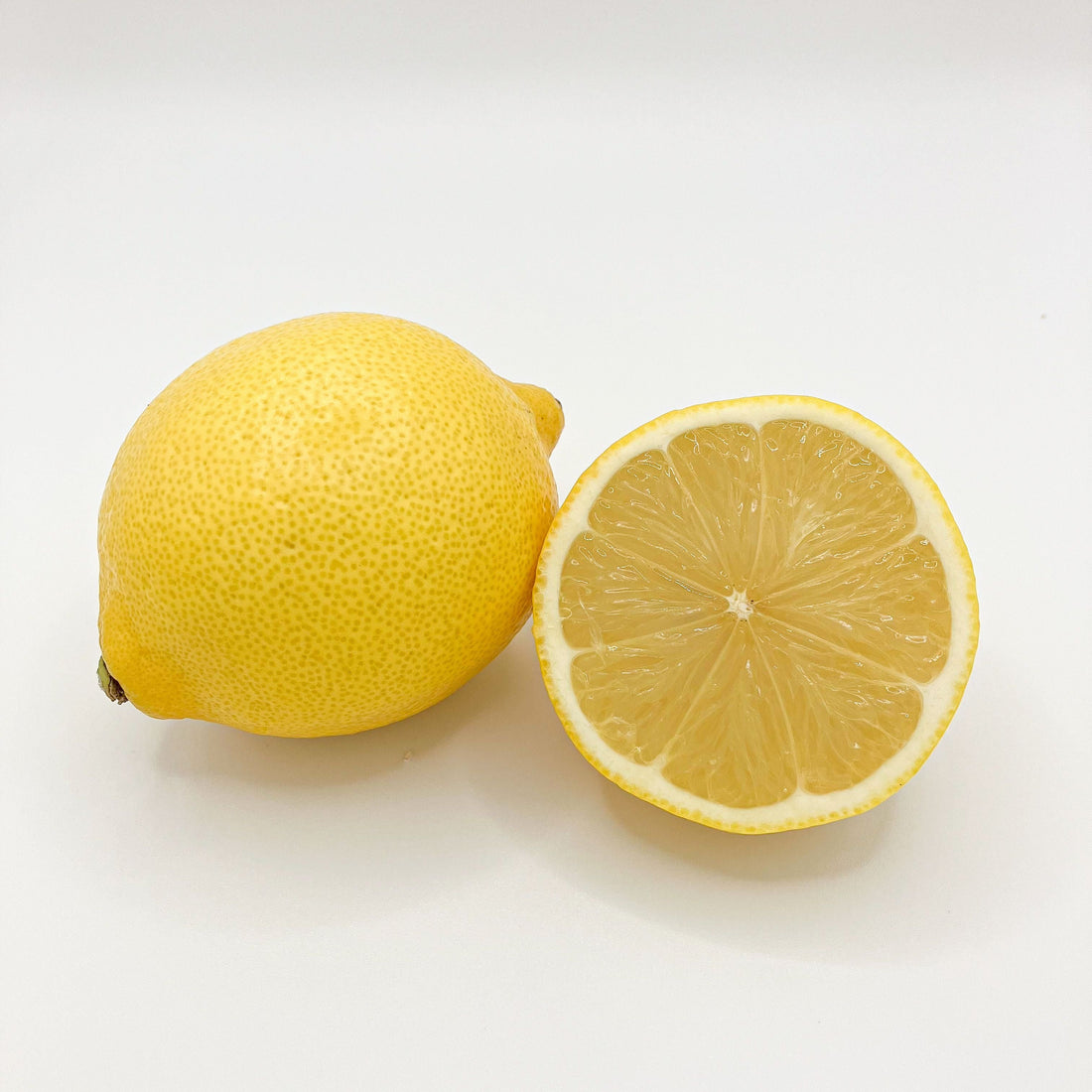 A whole lemon and a cut lemon illustrating sour flavor